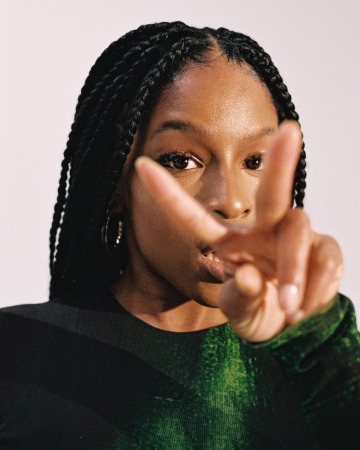 Julie Adenuga is posing for the photo.